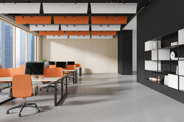istock Workplace interior with desks and pc monitors, shelf and panoramic window 2165202779