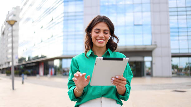 istock Female entrepreneur using a tablet in the city 2165203670