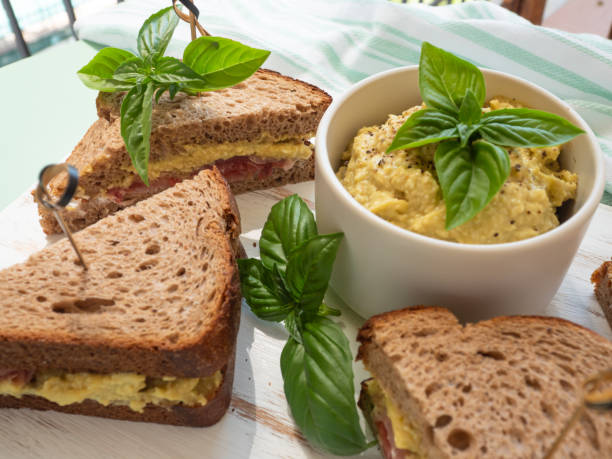 Rye bread sandwich with italian ham and avocado cashew spread