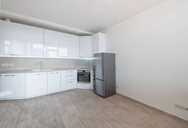 Front view of modern kitchen. Parquet floor and wooden beams