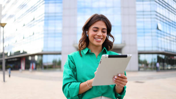istock Female entrepreneur using a tablet in the city 2165204674