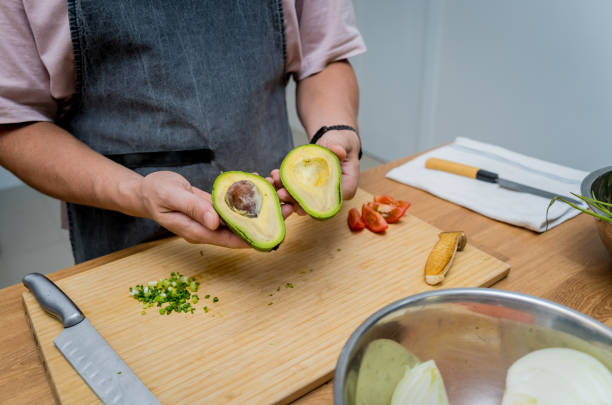 istock Chef at the kitchen preparing healthy quinoa bowl with avocado 2165204752