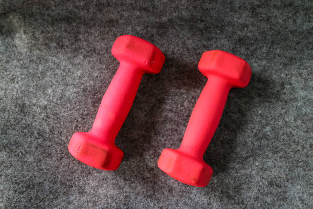 Two red 1kg dumbbells. Weights for a fitness training.