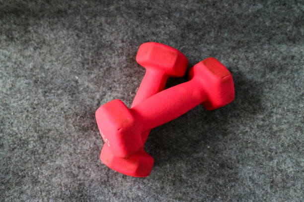 Two red 1kg dumbbells. Weights for a fitness training.