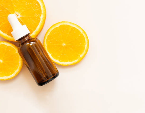 istock face serum with vitamin C, orange slices, packaging container 2165211629