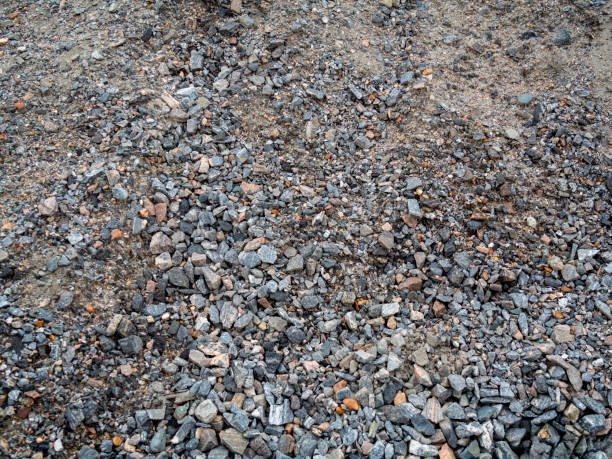 A background of mostly grey granite chippings, gravel and sand.