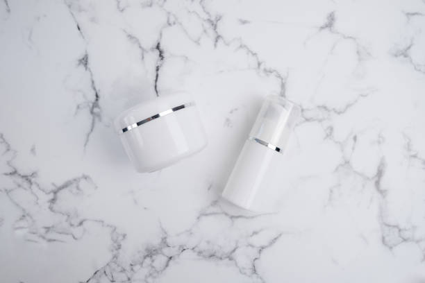 istock Container for cream, shampoo, toiletries, spa. Unbranded white plastic bottles. Bottle with a dispenser for cosmetic products. Skin care and beauty concept. Mockup style, copy space 2165216576