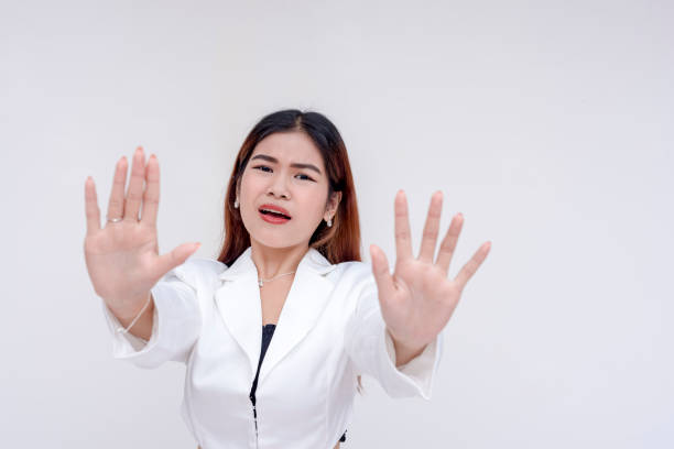 istock A young asian woman pleads someone to stop with both hands. 2165216672