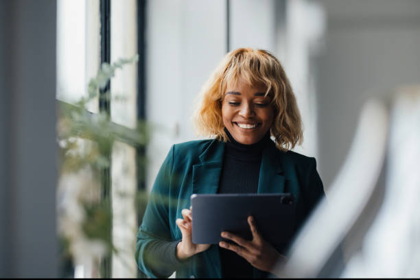 istock Blonde Businesswoman Smiling While Working at Office with Tablet 2165220533