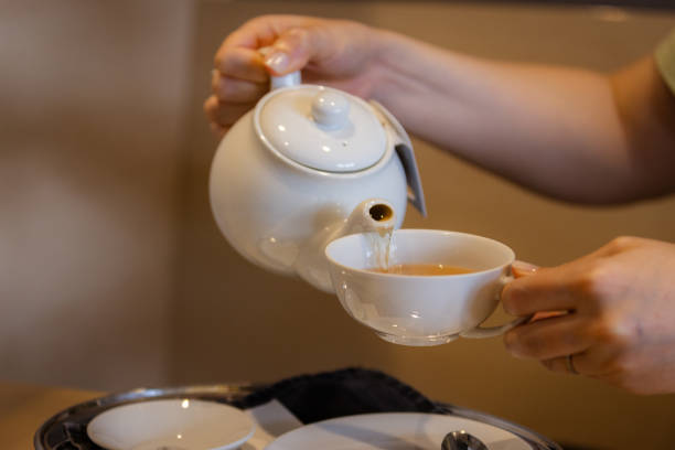 istock A woman is serving a hot tea. 2165221387