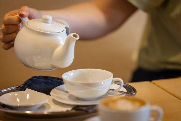 istock A woman is serving a hot tea. 2165221396