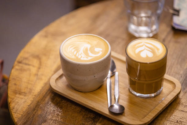 istock Two mugs of coffee with coffee art. 2165221424