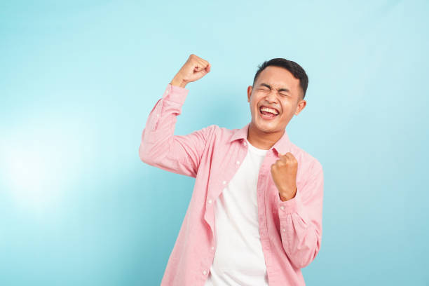 istock An excited man celebrates winning and happy expression 2165221563