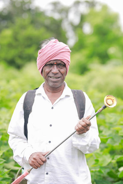 istock Indian farmer holding spray pump in hand 2165225062