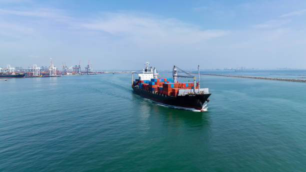 istock logistic cargo container ship sailing in sea import export goods and distributing products to dealer and consumers across worldwide, by container ship Transport business service 2165229712