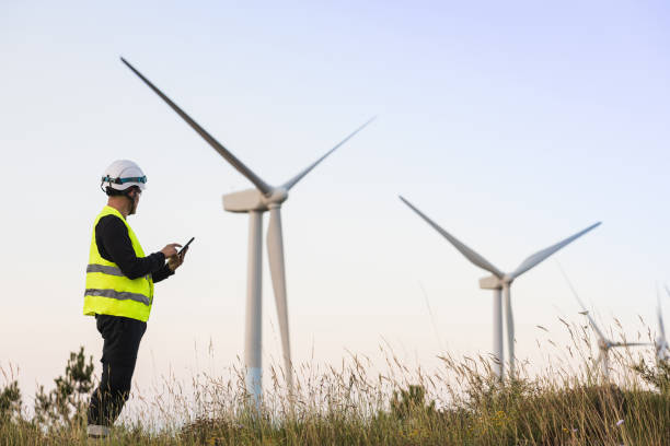 istock Wind turbine technician inspecting with digital tablet. 2165231638