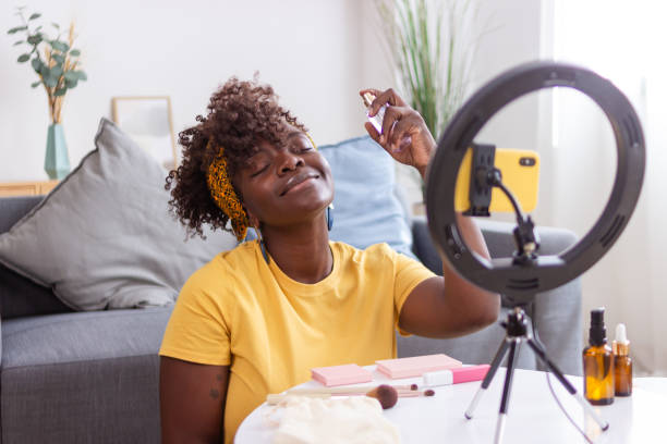 istock Beauty influencer applying perfume recording video using ring light and smartphone 2165237465