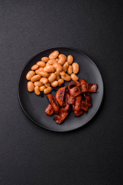 Fried sausages sliced with salt and spices as an ingredient for an English breakfast