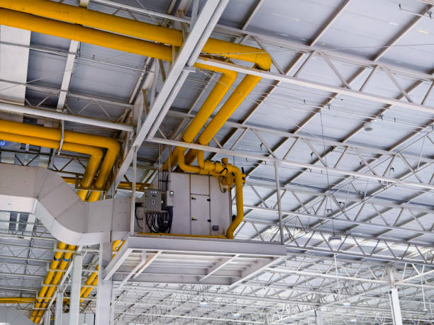 istock Ceiling with ventilation pipes and lights in industrial building 2165242062