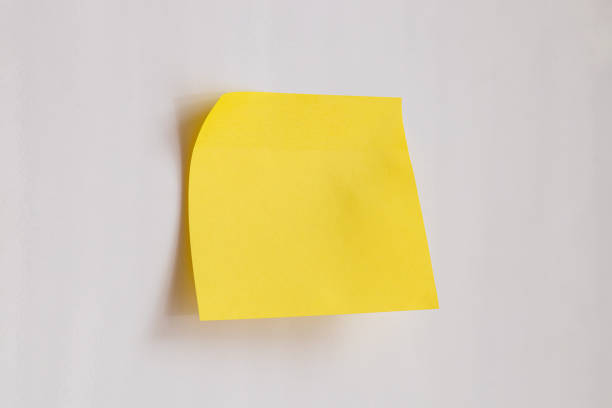 Top view of yellow sticky note paper on blue background
