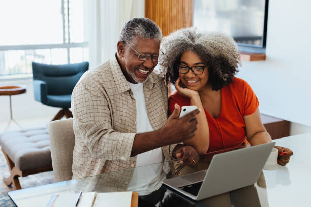 Senior couple using technology to manage budget at home