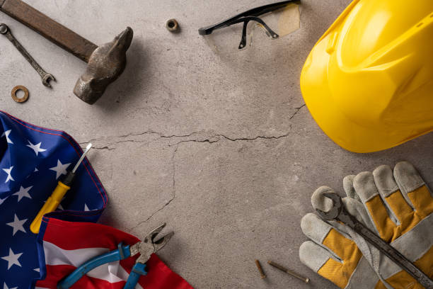 istock Labor Day theme showing various construction tools, safety gear and an American flag representing workforce celebration 2165250041