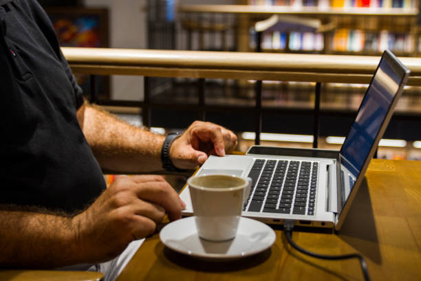 Businessman Working On His Laptop While Drinking His Coffee