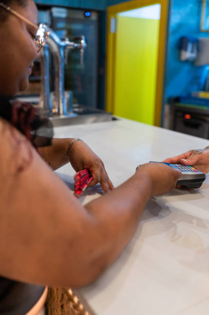 istock Customer paying bar tab with credit card at counter 2165251895