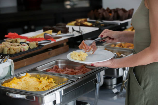 istock Woman taking food from a buffet line 2165252622