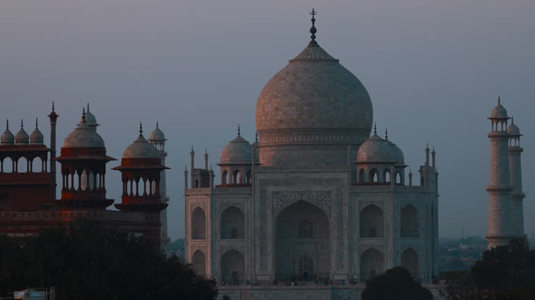 Taj Mahal In Agra, Uttar Pradesh, India. Sunset Dusk Timelapse Of Taj Mahal. Indian Islamic Heritage At Dusk. Seven World Wonders. Fabulous Taj Mahal Travel Concept. Crowds Of Tourists Visit Taj Mahal