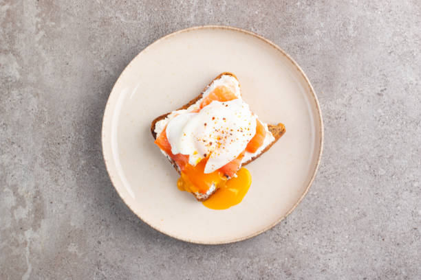 istock Poached egg on salmon and cheese toast. Breakfast food concept. Open sandwich. 2165254783
