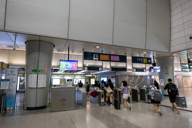 Hong Kong - August 4, 2024 : Passengers at the MTR Kowloon Station in Hong Kong. It is a station on the Tung Chung line and the Airport Express.