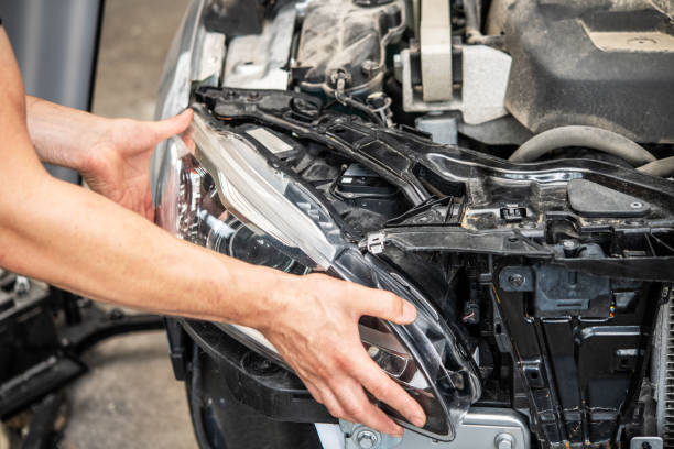 istock Automotive Maintenance: Skilled Mechanic Replacing Headlight in a Modern Vehicle Engine Compartment 2165260370