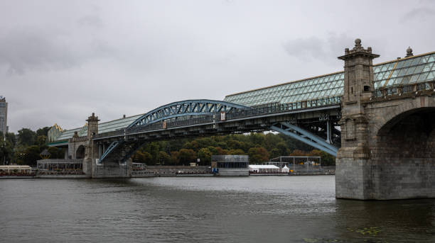 istock A Stunning Historic Bridge That Elegantly Spans Over the Serene River Beneath a Gloomy, Gray Sky 2165263989