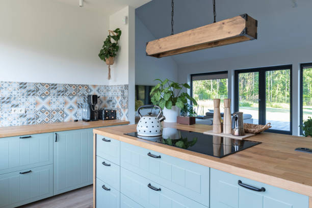 istock Modern kitchen with fashinable design and kitchen island with hanging lamp. Indoors architecture at new home. 2165264628
