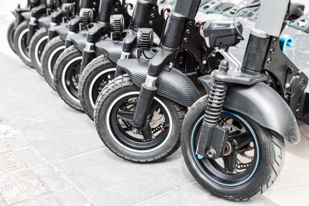 istock Scooters parked neatly in a row on a city sidewalk 2165266844