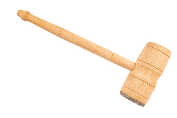 istock A wooden meat tenderizer, a kitchen tool used to tenderize meat before cooking. It has a long handle and a dual-sided head with one flat surface and one textured surface, designed for different types of meat or desired effects. 2165267706