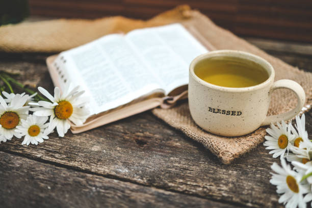 istock Cup with the inscription blessed and open Bible, Christian concept 2165270338