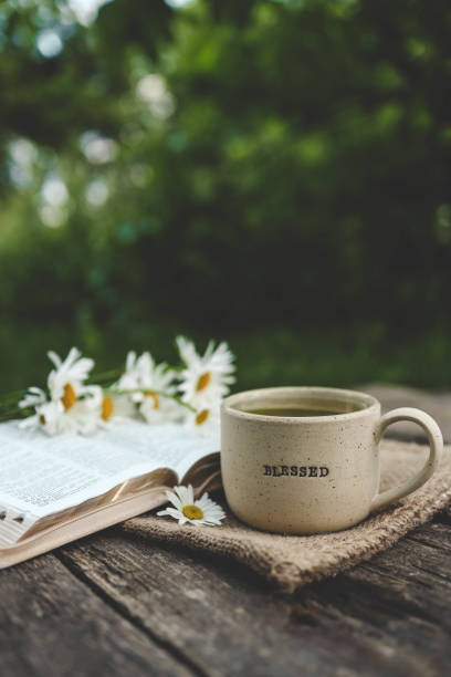 istock Cup with text BLESSED and open Bible in the garden, good morning 2165270340