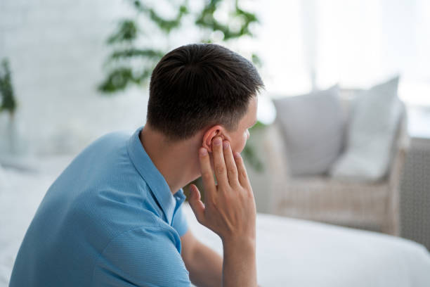 istock Man with earache, ear pain at home 2165270402
