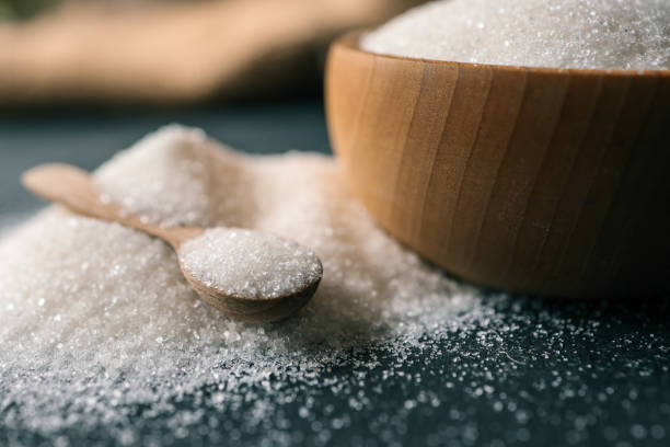 istock Wooden spoon with sugar on a plate 2165271236