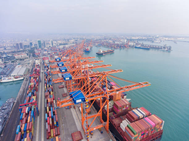 istock Aerial view of Cargo Container Ship approaching port with tugboat. 2165272603