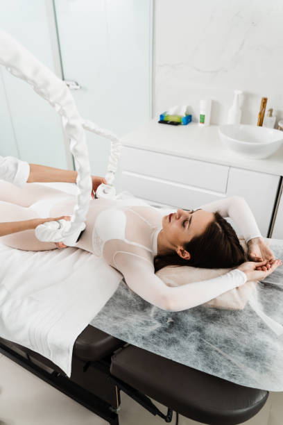 istock Lymphatic drainage apparatus is massaging woman sides. Effective therapy to remove destroyed fat sells. Massaging upper body to get rid of swelling. 2165281612