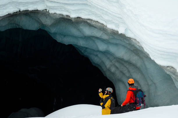 istock Guide leads guest on ice-cave tour 2165282850