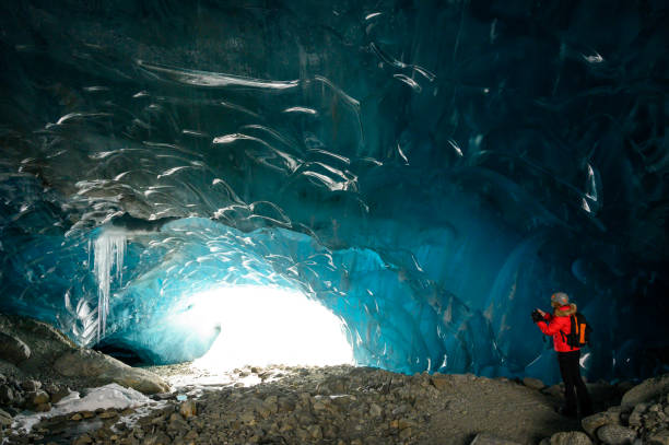 istock Guide leads guests on ice-cave tour 2165283174