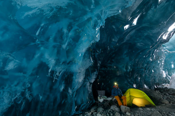 istock Explorer camps with tent in ice cave 2165283605