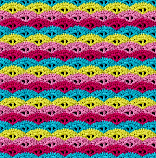 istock Bright seamless knitted texture. The pattern in the form of seashells is crocheted with multi-colored threads. 2165284593