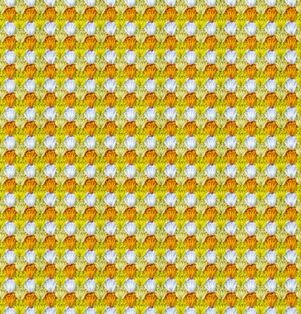 Seamless knitted texture in the form of flower buds. The pattern is crocheted from multicolored cotton yarn. Bright summer range of shades.