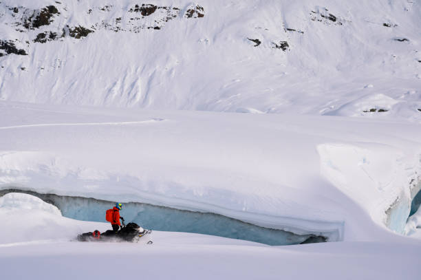 istock Backcountry snowmobiler rides across glacier 2165285702