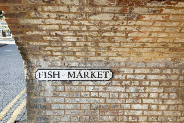 istock Fish market sign on weathered brick wall 2165285853